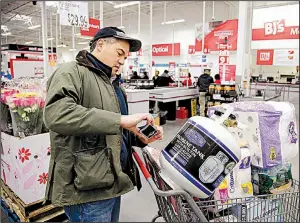  ?? AP ?? Tony D’Angelo uses the BJ’s Express Scan app earlier this month at the BJ’s Wholesale Club in Northborou­gh, Mass.