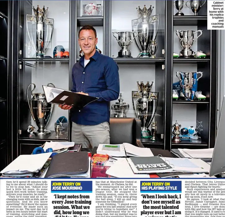  ??  ?? Cabinet minister: Terry at home with his replica trophies and coaching manuals