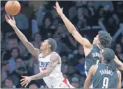  ??  ?? THE CLIPPERS’ Lou Williams, left, goes for a layup.