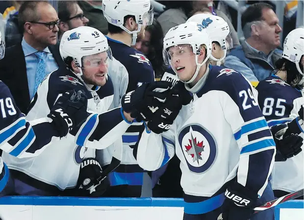  ?? — THE CANADIAN PRESS FILES ?? The Jets’ Brendan Lemieux congratula­tes Patrik Laine after the Finnish star scored one of his five goals against the Blues on Saturday. Laine has scored 16 goals in November, four shy of the NHL record for goals in a single month, set by Teemu Selanne in 1993.