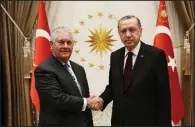  ?? AP ?? Turkish President Recep Tayyip Erdogan (right) greets U.S. Secretary of State Rex Tillerson before their talks Thursday at the presidenti­al palace in Ankara.