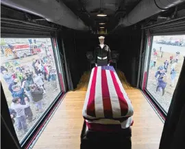  ?? DAVID J. PHILLIP/AP ?? On Thursday, the flag-draped casket of former President George H.W. Bush passes through Magnolia, Texas.