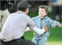  ?? PHOTO BY ORLANDO RAMIREZ/AFP ?? THE PRIZE
Nick Taylor of Canada celebrates with son Charlie after winning in a two-hole playoff during the final round of the WM Phoenix Open at TPC Scottsdale on Sunday, Feb. 11, 2024, in Scottsdale, Arizona.