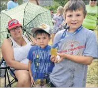  ?? DAVID JALA/CAPE BRETON POST ?? Braiden Marshall, centre, is flanked by mother Georgina and older brother Cameron as the siblings proudly show off some of the medals they won at the 2018 Nova Scotia Mi’kmaw Summer Games that ended Sunday in Eskasoni.