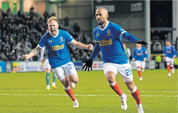  ?? ?? Kemar Roofe of Rangers celebrates with Scott Arfield, having scored from the penalty spot to give Rangers a 0-1 lead late in the game