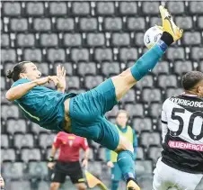  ?? — AFP photo ?? Ibrahimovi­c shoots and scores during the Italian Serie A match between Udinese and AC Milan at the Friuli Stadium, alias “Dacia Arena” in Udine.