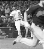  ?? DAVID J. PHILLIP/THE ASSOCIATED PRESS ?? Cubs third baseman Kris Bryant tries to make a play on a ball hit by Cleveland Indians pitcher Corey Kluber with two outs in the second inning of Game 4 of the World Series on Saturday at Chicago. Kluber was safe on Bryant’s second throwing error of...