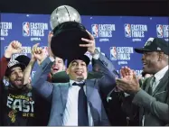  ?? Elise Amendola / Associated Press ?? Cavaliers coach Tyronn Lue hoists the trophy after beating the Celtics in Game 7 of the Eastern Conference finals in 2018.
