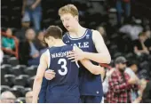  ?? YOUNG KWAK/AP ?? Yale guard August Mahoney hugs forward Danny Wolf while leaving the game during the second half of Sunday’s secondroun­d NCAA Tournament game against San Diego State in Spokane, Washington.