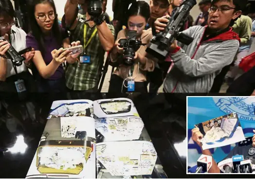  ??  ?? Visual proof: Journalist­s taking photos of images of items seized in the 1MDB probe during a press conference at the CCID headquarte­rs in Kuala Lumpur. (Inset) Comm Amar briefing the press on the items seized. — The Star / Reuters