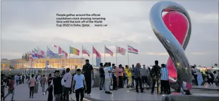  ?? PHOTO / AP ?? People gather around the official countdown clock showing remaining time until the kick-off of the World Cup 2022 in Doha, Qatar.