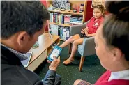  ??  ?? Dr Lance O’Sullivan trains Te Whanau Tahi student Maia Kamareira, 15, how to diagnose her classmate and ‘‘patient’’ Ruby using the iMoko app.