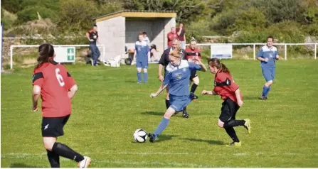  ??  ?? Lexi Musgrave (blue) scored twice for Amlwch Town against Point last weekend