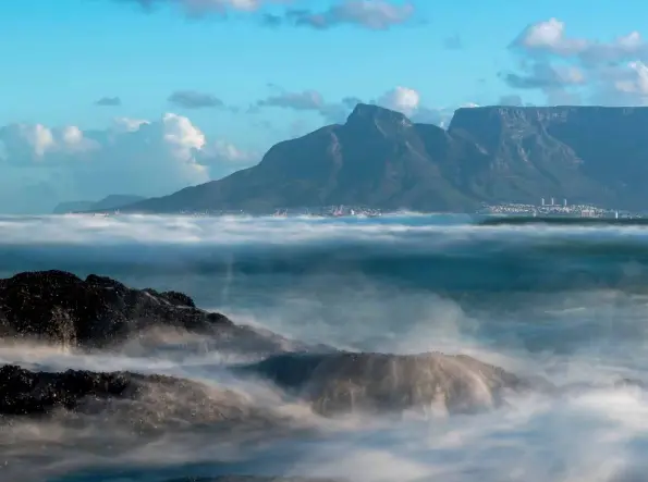  ??  ?? ABOVE
The timeless view of Table Mountain from Blouberg remains a Cape photograph­ic staple – enhanced by an unusual low-angle foreground and surf in motion.