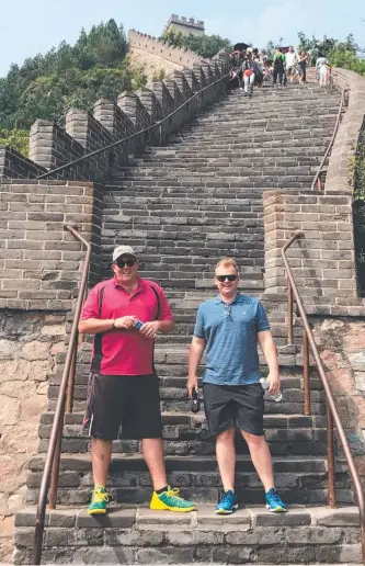  ??  ?? STEPPING UP: Factory Buys partners Nathan Longhurst ( left) and Shane Scholefiel­d tackle the Great Wall of China during a recent trip.