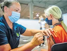  ?? ?? A girl receives the Covid-19 jag at a vaccinatio­n centre in Nieuwegein in The Netherland­s