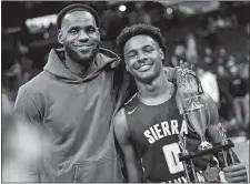  ?? JAY LAPRETE/AP PHOTO ?? In this Dec. 14, 2019, file photo, LeBron James, left, poses with his son Bronny after Sierra Canyon beat Akron St. Vincent-St. Mary in a high school basketball game in Columbus, Ohio.