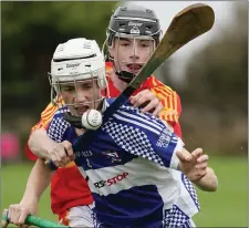  ??  ?? Horeswood’s Conor Foley tackles Ryan Cullen (Oylegate-Glenbrien).