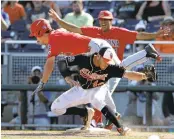  ?? NATI HARNIK/ASSOCIATED PRESS ?? Arizona’s Justin Behnke (4) is safe at first after colliding with Oklahoma State’s first baseman. The Wildcats won.