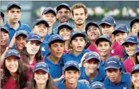  ?? PICTURE: GETTY IMAGES ?? SPOT THE WINNER: Scotland’s Andy Murray with the winners trophy along side the ball boys and girls after his Madrid Open victory over Rafael Nadal yesterday.