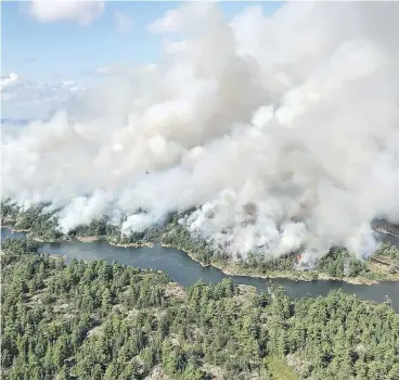  ?? DAN LEONARD / RESPONSE SPECIALIST / AFFES IGNITION / THE CANADIAN PRESS ?? An aerial view shows the extent of the Parry Sound 33 fire being fought in Ontario by firefighte­rs from across Canada, the United States and Mexico. The wildfire could force the closure of a stretch of the Trans-Canada Highway.