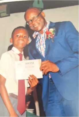  ?? ?? A young and ambitious Ashley poses for a picture during a prize-giving day at Eaglesvale Preparator­y School with one of the staffers