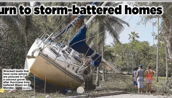  ??  ?? Wrecked boats that have come ashore are pictured in a coconut grove after Hurricane Irma battered Miami on Monday. REUTERS