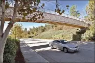  ?? Dan Watson/The Signal ?? A car passes under the Fairview Drive paseo bridge. City commission­ers are discussing the possibilit­y of creating a plaque to honor Fereydoon Ghaffari, one of the contributo­rs responsibl­e for the area’s multiuse trail system.