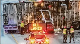  ?? JOHN SPINK / JSPINK@ AJC. COM ?? A tractor- trailer hauling 19 cows overturned on I- 75 South before 5 a. m. on Thursday, causing the road to be closed for about three hours.