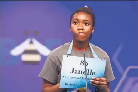  ?? Cliff Owen / Associated Press ?? Janelle Newell, 11, of Bridgeport, spells her word during the 2nd round of the Scripps National Spelling Bee in Oxon Hill, Md., on Tuesday.