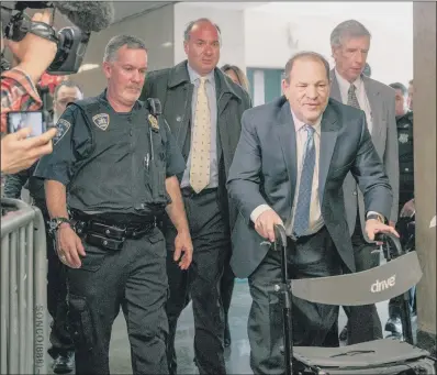  ?? PICTURE: SCOTT HEINS/GETTY IMAGES ?? POWERFUL DAY: Disgraced film mogul Harvey Weinstein, right, entering New York City Criminal Court yesterday with the aid of a mobility walker. It was one of his most prominent accusers, Rose McGowan, who called it ‘a powerful day’.