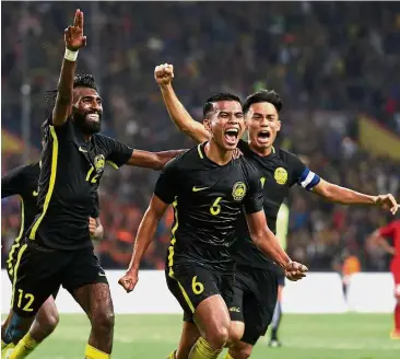  ??  ?? Glorious day: Malaysia’s N. Thanabalan (left) and teammates celebratin­g their victory over Singapore last Wednesday. They will be hoping for another good outing against Myanmar in a Group A match at the Shah Alam Stadium tonight.