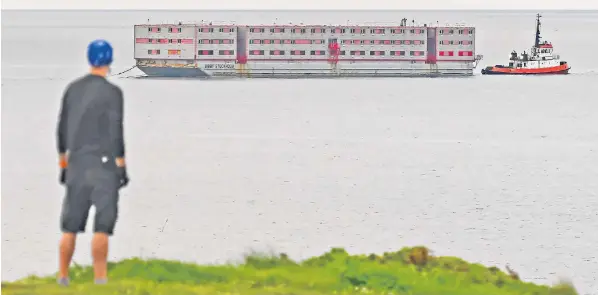  ?? ?? Bibby Stockholm, the migrant barge, arrives at Falmouth, Cornwall, yesterday for inspection before it is converted to house more than 500 asylum seekers from next month in Portland Port in Dorset