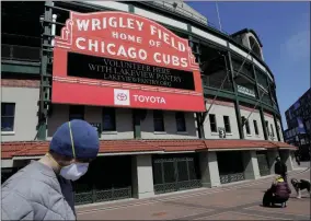  ?? NAM Y. HUH - THE ASSOCIATED PRESS ?? FILE - In this April 16, 2020 file photo, Wrigley Field’s marquee displays Lakeview Pantry volunteer informatio­n in Chicago.