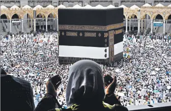  ?? AMR NABIL/AP ?? A Muslim pilgrim prays Friday as thousands of other pilgrims make their way around the Kaaba at the Grand Mosque ahead of the hajj pilgrimage in Mecca, Saudi Arabia.