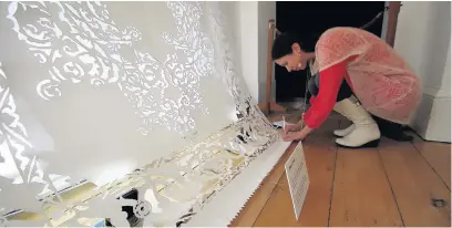  ??  ?? ●● Artist Maryam Golubeva works on an intricate paper design for the On Paper Festival