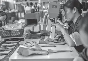  ?? GILLES SABRIE/THE NEW YORK TIMES ?? Workers assemble shoes in December at a Huajian Internatio­nal shoe factory, which makes footwear for Ivanka Trump and other designers, in Dongguan, China.