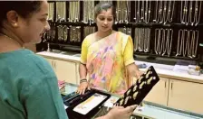  ?? K. MURALI KUMAR ?? A customer buying gold jewellery at a store in Basavanagu­di in Bengaluru on Friday.
