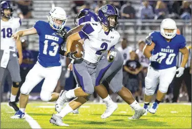  ?? Special to NWA Democrat-Gazette/DAVID BEACH ?? Connor Flannigan (center) of Fayettevil­le runs the ball against Rogers High on Friday at Whitey Smith Stadium in Rogers.