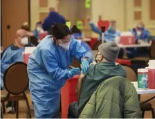  ?? NiCOLAuS CzARnECki / hERALd STAFF FiLE ?? BUSY VENUE: Medical personnel work on giving coronaviru­s vaccinatio­ns to people at the mass vaccinatio­n site in Danvers on Saturday. High-risk numbers have fallen as the state’s efforts to vaccinate the public have solidified.