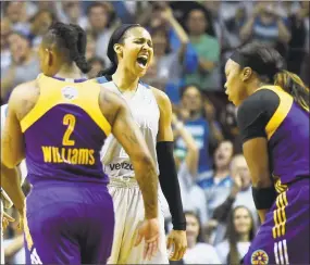  ?? Hannah Foslien / Getty Images ?? Maya Moore, a former UConn star, of the Lynx celebrates as Riquna Williams (2) and Odyssey Sims of the Sparks react in the final minute on Wednesday in Minneapoli­s.