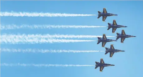  ?? PHOTOS DAN JANISSE ?? Jets from the United States navy flight demonstrat­ion squadron Blue Angels soar in formation Tuesday over Detroit to thank front-line workers dealing with the COVID-19 pandemic. The squadron’s busy summer air-show schedule has been cancelled because of the pandemic.