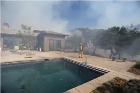  ?? Photograph: Jim Urquhart/Reuters ?? Firefighte­rs work to defend homes from an approachin­g wildfire in Sonoma, California.