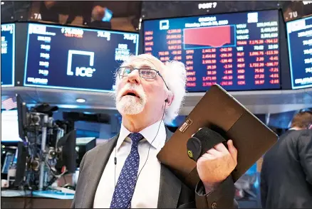  ??  ?? In this file photo, trader Peter Tuchman works on the floor of the New York Stock Exchange. Trading on the NYSE went all-electronic for the first time March 23 after the exchange temporaril­y closed its trading floor as a precaution after two employees tested positive last week for the coronaviru­s. ‘Things are sort of seamless, as far as speed and execution go,’ said Tuchman. He’s usually on the NYSE floor trading for Quattro Securities but
now working from home. (AP)