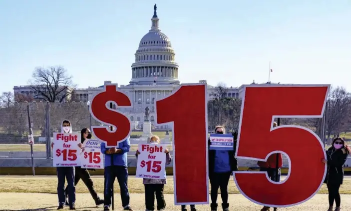  ??  ?? Activists appeal for a $15 minimum wage near the Capitol in Washington DC on 25 February. Photograph: J Scott Applewhite/AP