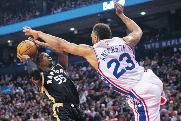  ?? NATHAN DENETTE / THE CANADIAN PRESS ?? Toronto Raptors guard Delon Wright drives into Philadelph­ia 76ers guard Justin Anderson during NBA action Sunday in Toronto.