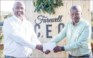  ?? ?? ESA Acting CEO Banele Nyamane presents Dr Phil Mnisi with documents of a beast which was a gift from the company.