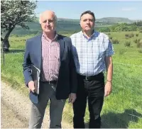  ??  ?? Paul Bradburn, of the Edenfield Residents Associatio­n (left) with Ian Lord, chairman of the Edenfield Community Neighbourh­ood Forum, at the site of the proposed developmen­t off Market Street in Edenfield