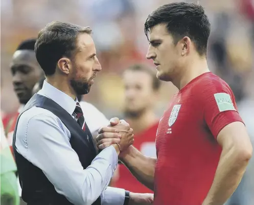  ?? ?? 0 England manager Gareth Southgate, left, retains faith in defender Harry Maguire, who has struggled for form at Manchester United