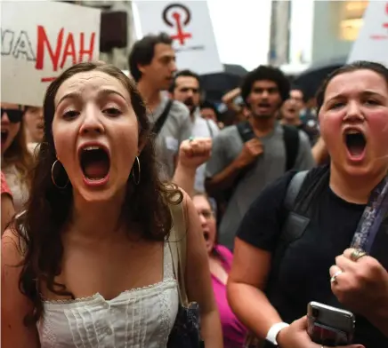  ?? PHOTO: AFP/ GETTY ?? Protest: Women take to the street in front of Trump Tower yesterday in New York